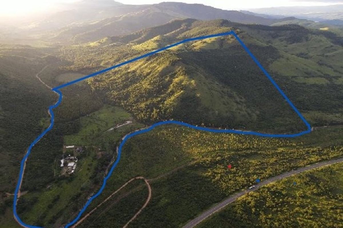 An aerial view of the expansive lodge property, highlighting the vast natural landscape, surrounding hills, and the site boundaries.