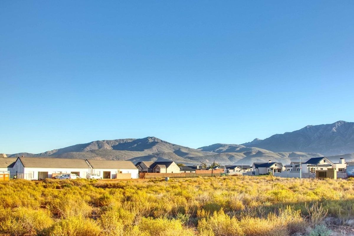 A scenic view of the surrounding landscape and mountain range from the vacant residential plot.