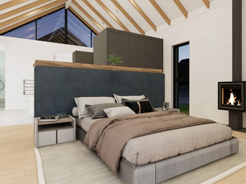 Spacious open-plan bedroom featuring vaulted ceilings with exposed beams, a modern built-in fireplace, and an integrated en-suite bathroom area.