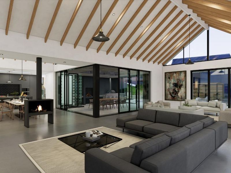 Spacious open-plan living area featuring vaulted ceilings with exposed timber beams, a modern fireplace, and seamless integration with a contemporary kitchen and dining space.
