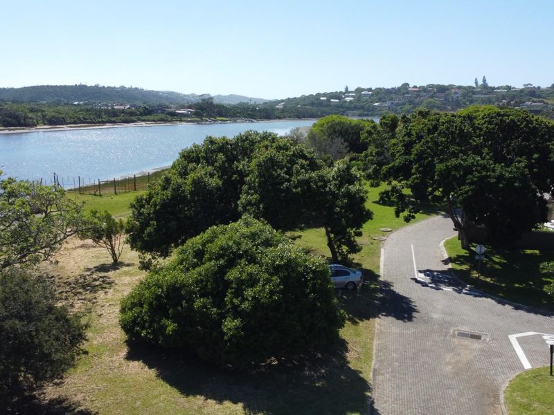 Aerial view of the residential land parcel featuring established trees, paved access road, and scenic views overlooking the nearby river and surrounding landscape.
