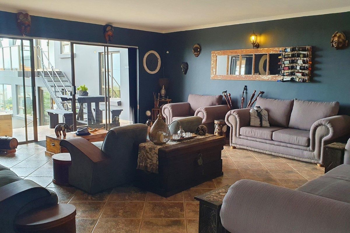Spacious living room featuring tiled flooring and large sliding glass doors that provide seamless access to the outdoor patio area.