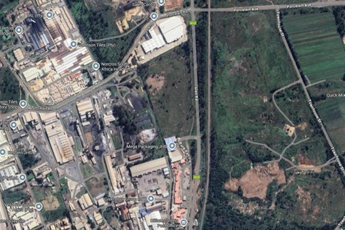 An aerial satellite view showing the surrounding industrial area, road infrastructure, and commercial property locations.