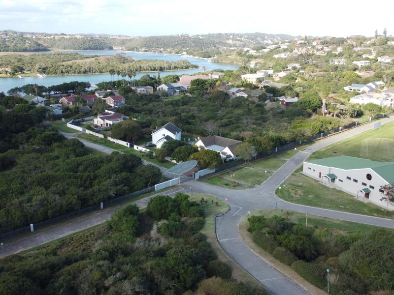Aerial view of the residential estate, showcasing the surrounding landscape, nearby river, and local infrastructure.