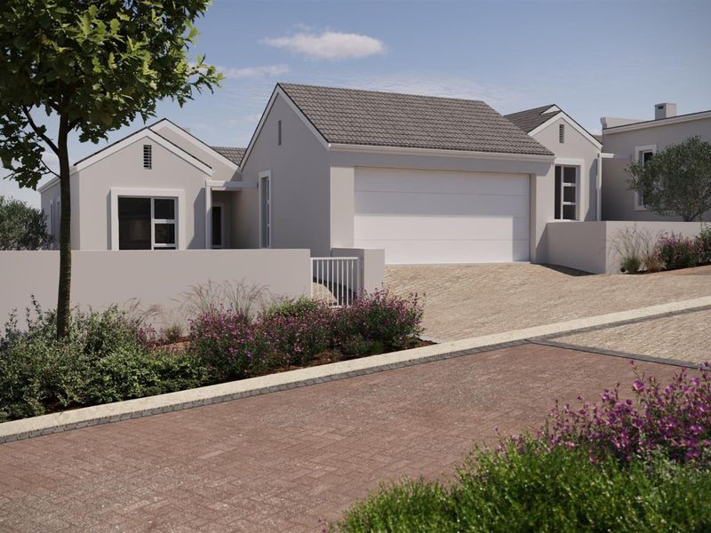 A modern residential exterior featuring a tiled roof, a secure garage, and a paved driveway with landscaped garden borders.