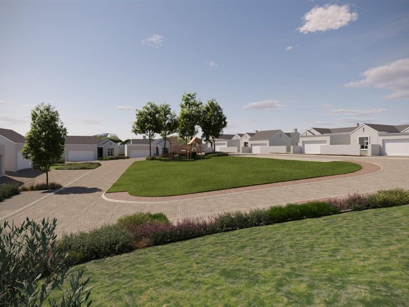 A wide-angle view of a modern residential estate featuring paved driveways, manicured lawns, and multiple garage-fronted homes.