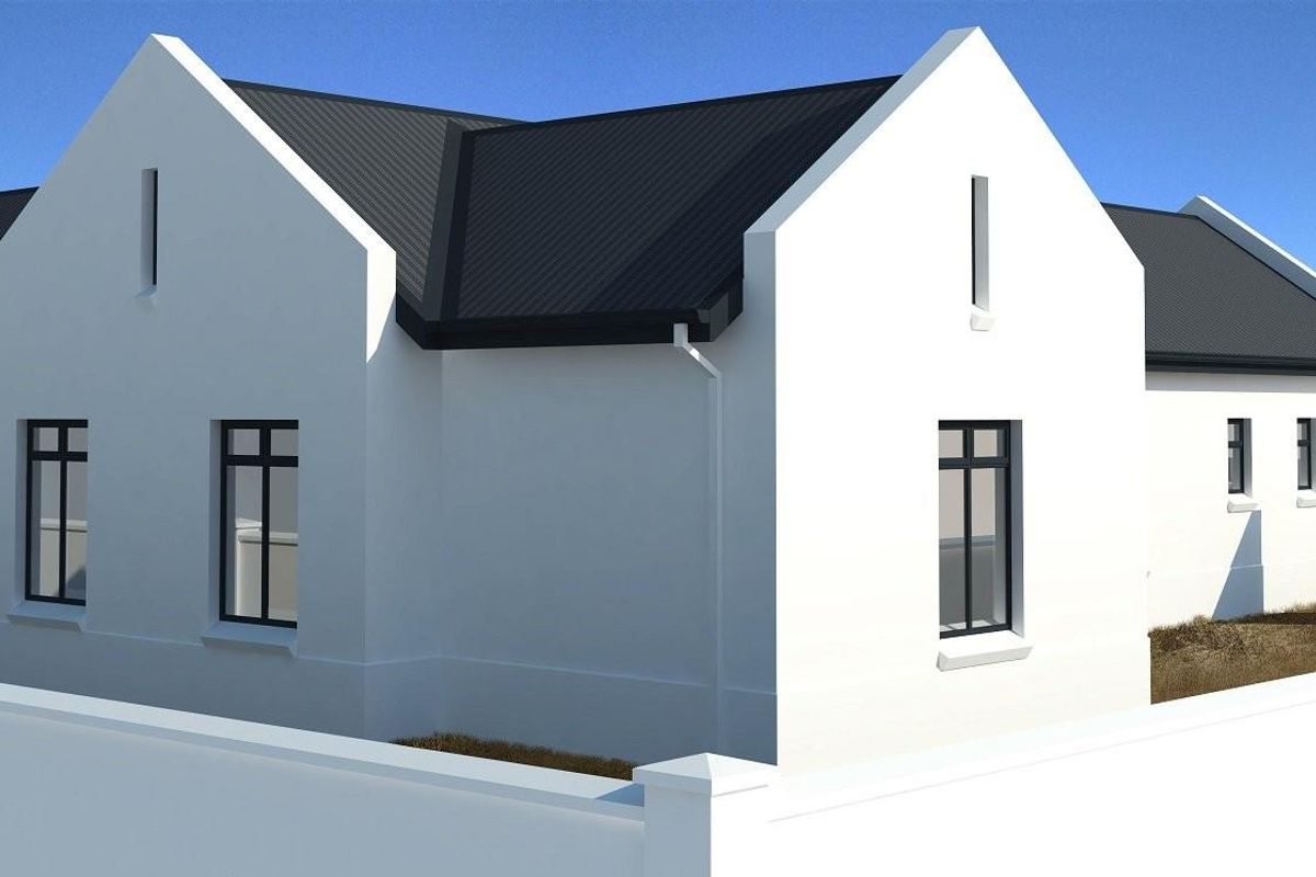A modern, newly constructed house featuring a clean white facade, dark metal roof, and perimeter boundary wall.