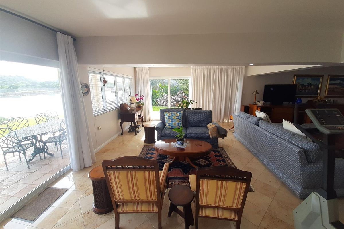 Spacious living area featuring large sliding glass doors that provide natural light and seamless access to the outdoor patio.