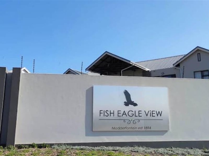 Exterior view of the Fish Eagle View complex entrance, featuring a secure perimeter wall with integrated electric fencing and prominent estate signage.