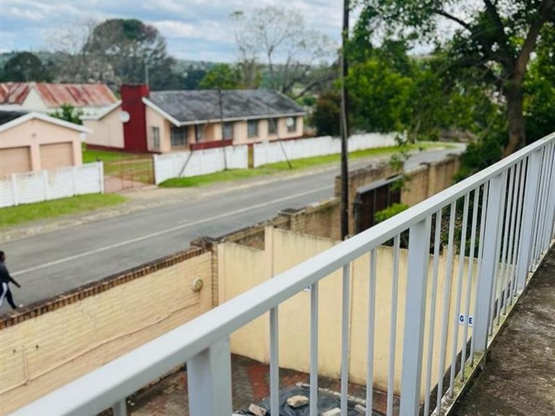 An elevated balcony featuring a metal balustrade with views overlooking the street and surrounding neighbourhood.