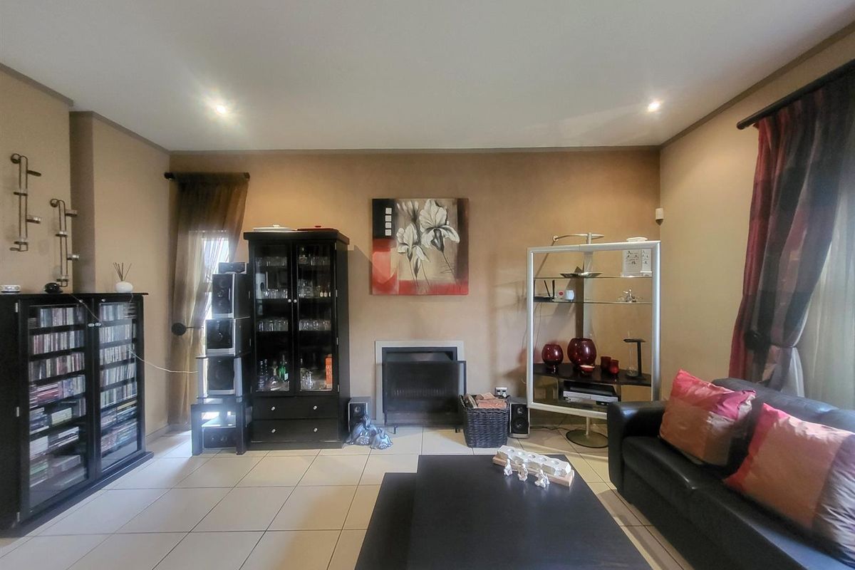 A living room featuring tiled flooring and a built-in fireplace, providing a comfortable and functional space for relaxation.