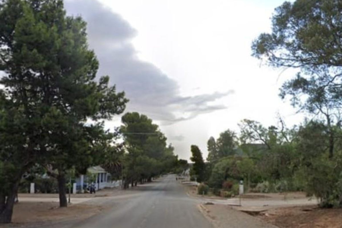 A street view perspective of Wehmeyer Street, showing the paved road surface and surrounding mature trees in a residential neighborhood setting.
