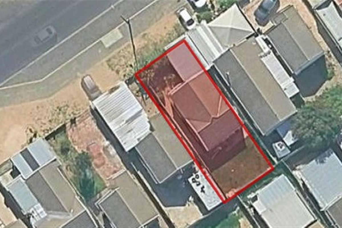 Aerial view of the property highlighting the building footprint and surrounding residential plot layout.
