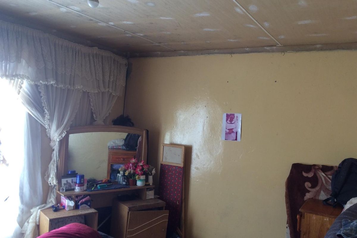 A bedroom featuring an unfinished ceiling and painted walls, requiring cosmetic updates to improve the overall aesthetic and finish.
