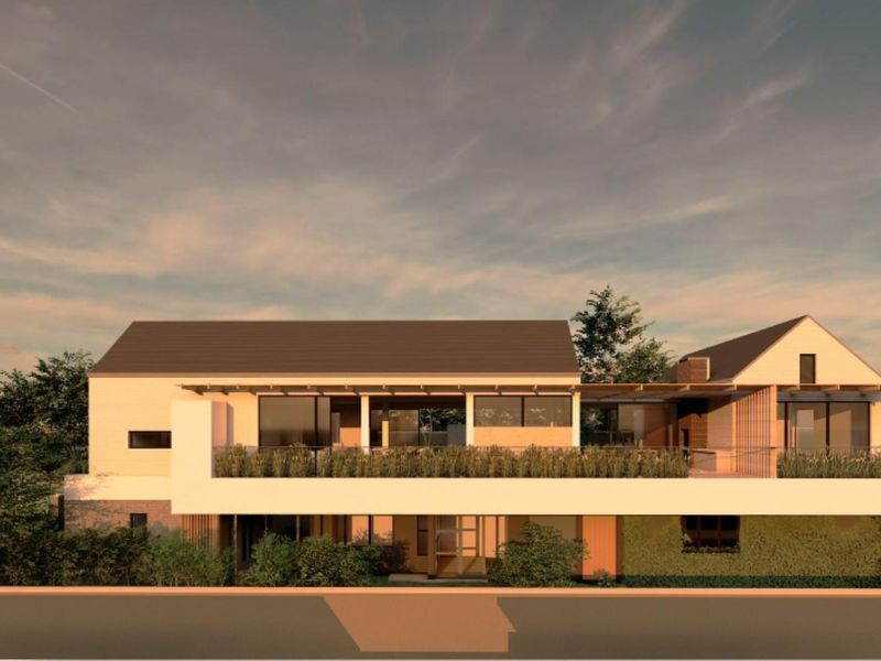A modern architectural rendering of a residential property featuring a pitched roof, expansive balcony, and contemporary timber and glass facade elements.