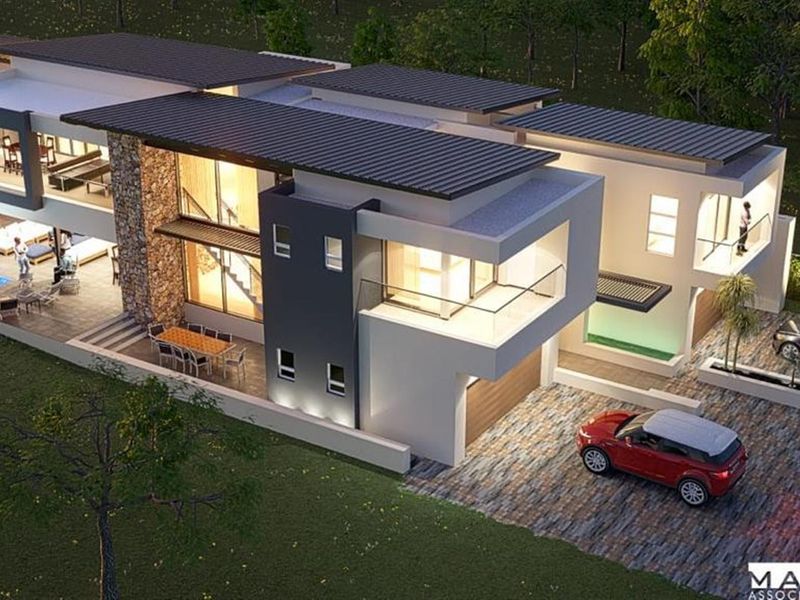An aerial perspective of a modern luxury residence featuring stone accents, a swimming pool, multiple balconies, and a paved driveway.