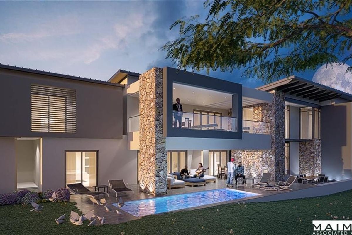 Modern luxury residence featuring a rear patio, swimming pool, stone-clad architectural elements, and expansive glass sliding doors for seamless indoor-outdoor living.