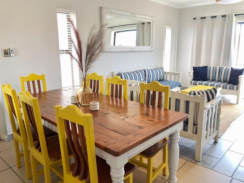 Open plan living and dining area featuring tiled flooring and neutral wall finishes, providing a versatile space for relaxation and entertaining.