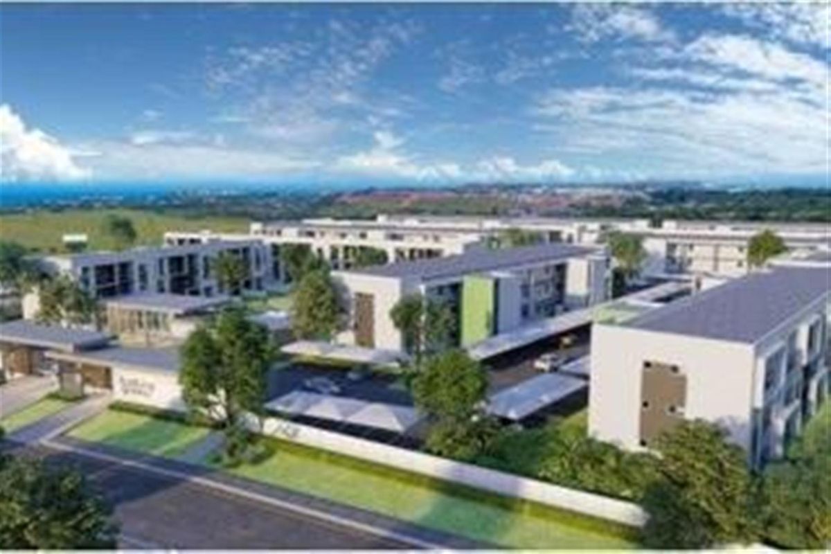 An aerial perspective of a modern apartment complex featuring multiple residential blocks, landscaped common areas, and covered parking facilities.