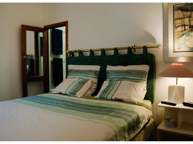 A bedroom featuring a doorway leading to an adjacent bathroom area.