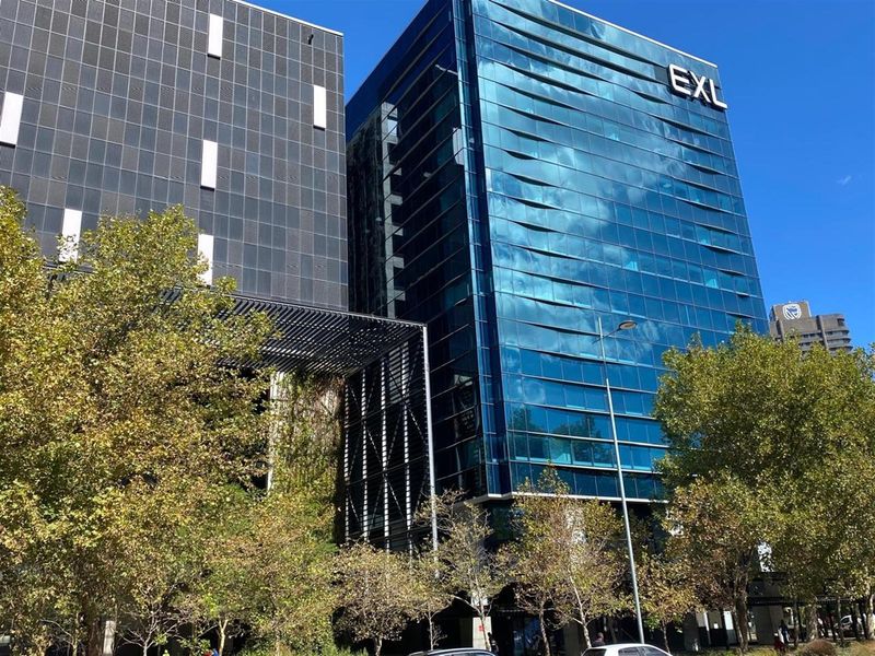 Modern high-rise office building featuring a contemporary glass facade and architectural metal detailing in a prominent urban location.