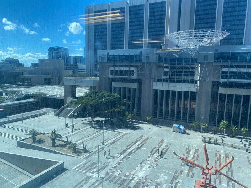 Elevated view overlooking a modern urban plaza and surrounding office building architecture.