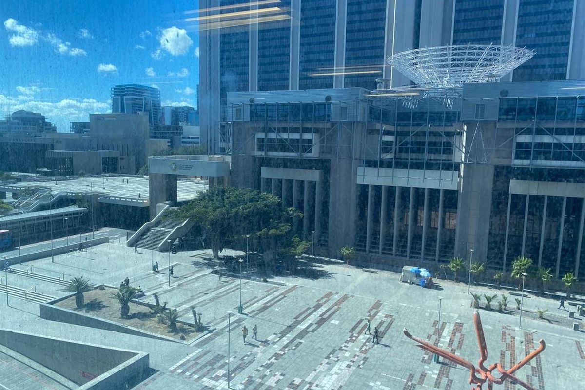 Elevated view overlooking a modern urban plaza and surrounding office building architecture.