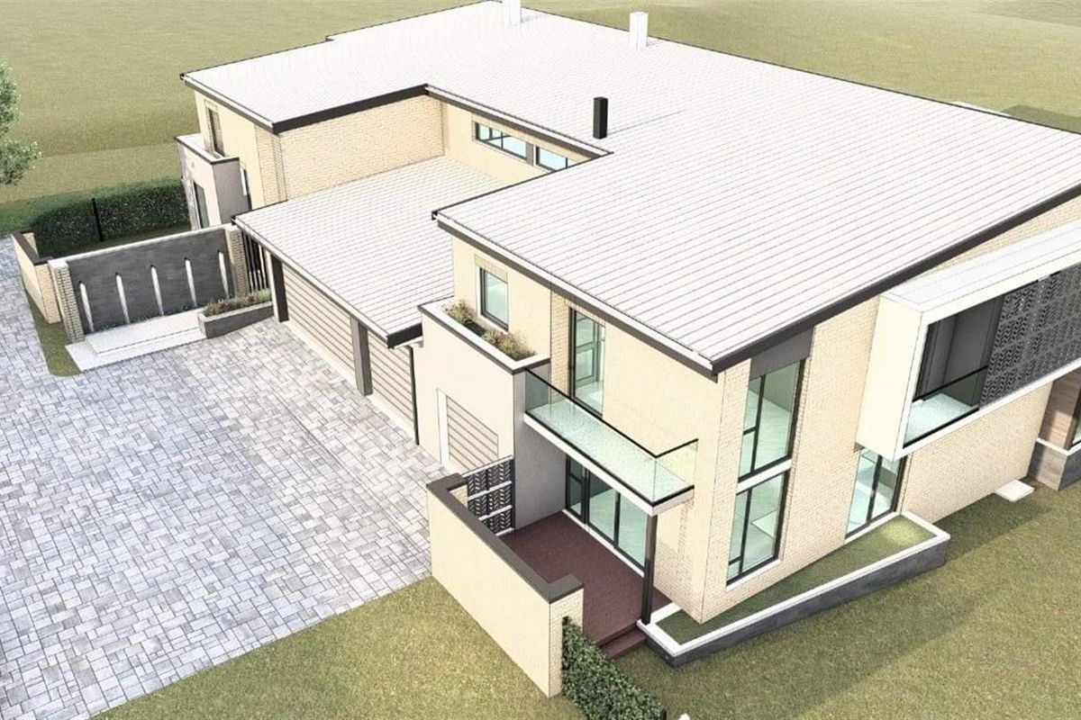 An aerial view of a modern two-story house featuring a paved driveway, integrated garage, and contemporary architectural design with glass balcony railings.