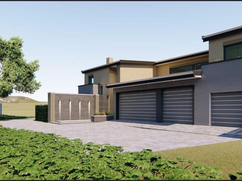 A modern architectural rendering of a residential property featuring a triple garage, paved driveway, and a decorative water feature wall.