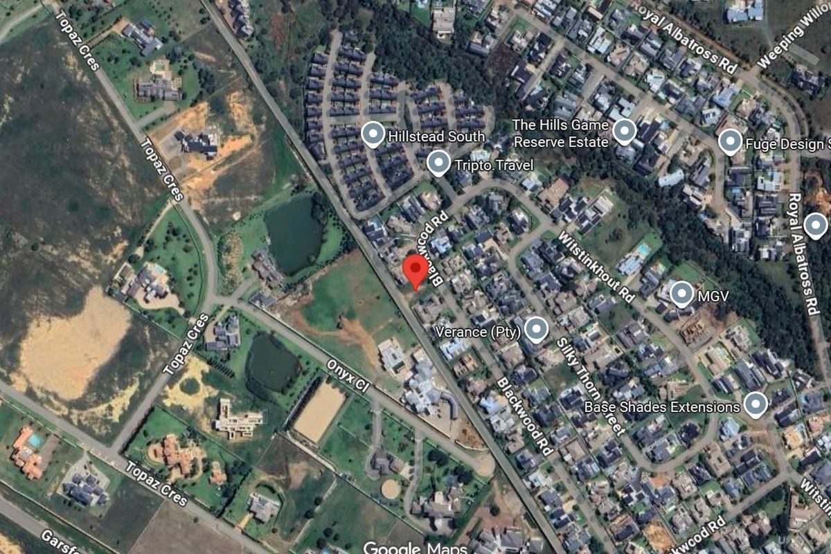 An aerial satellite view of the residential estate showing the location of the vacant land plot within the established neighborhood.