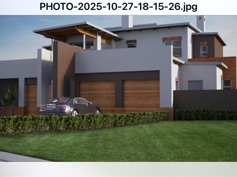 A modern residential property featuring a double garage, contemporary architectural design, and a well-maintained front lawn.