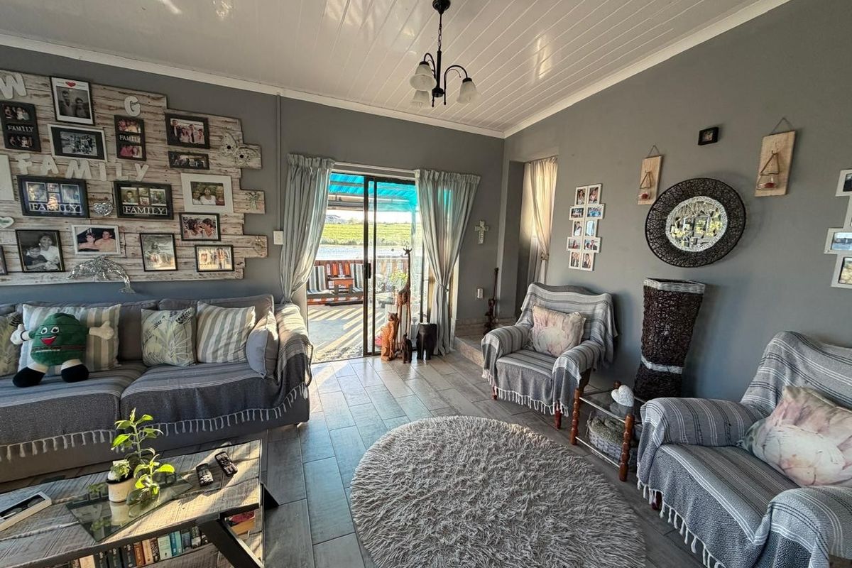 A comfortable living room featuring tiled flooring, a tongue and groove ceiling, and a sliding glass door providing access to the outdoor patio area.