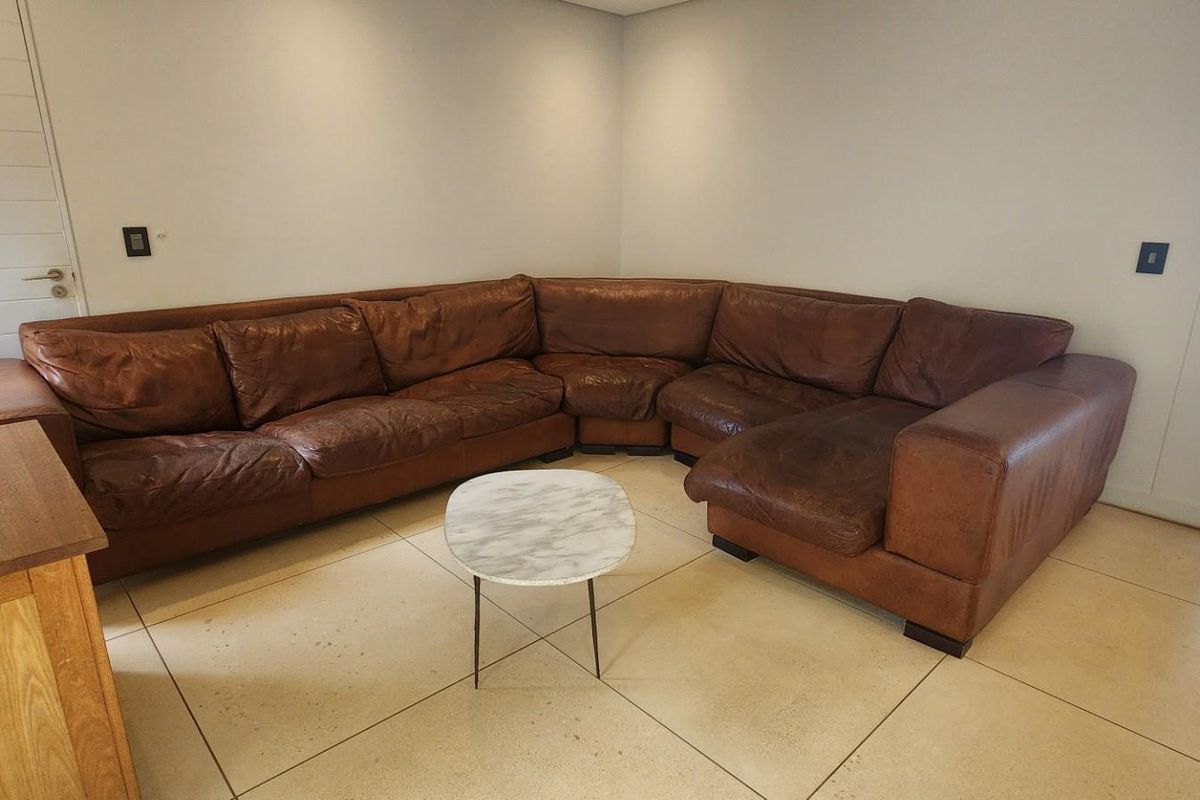 A spacious living room featuring large format floor tiles and neutral wall finishes, providing a clean and versatile foundation for the living area.