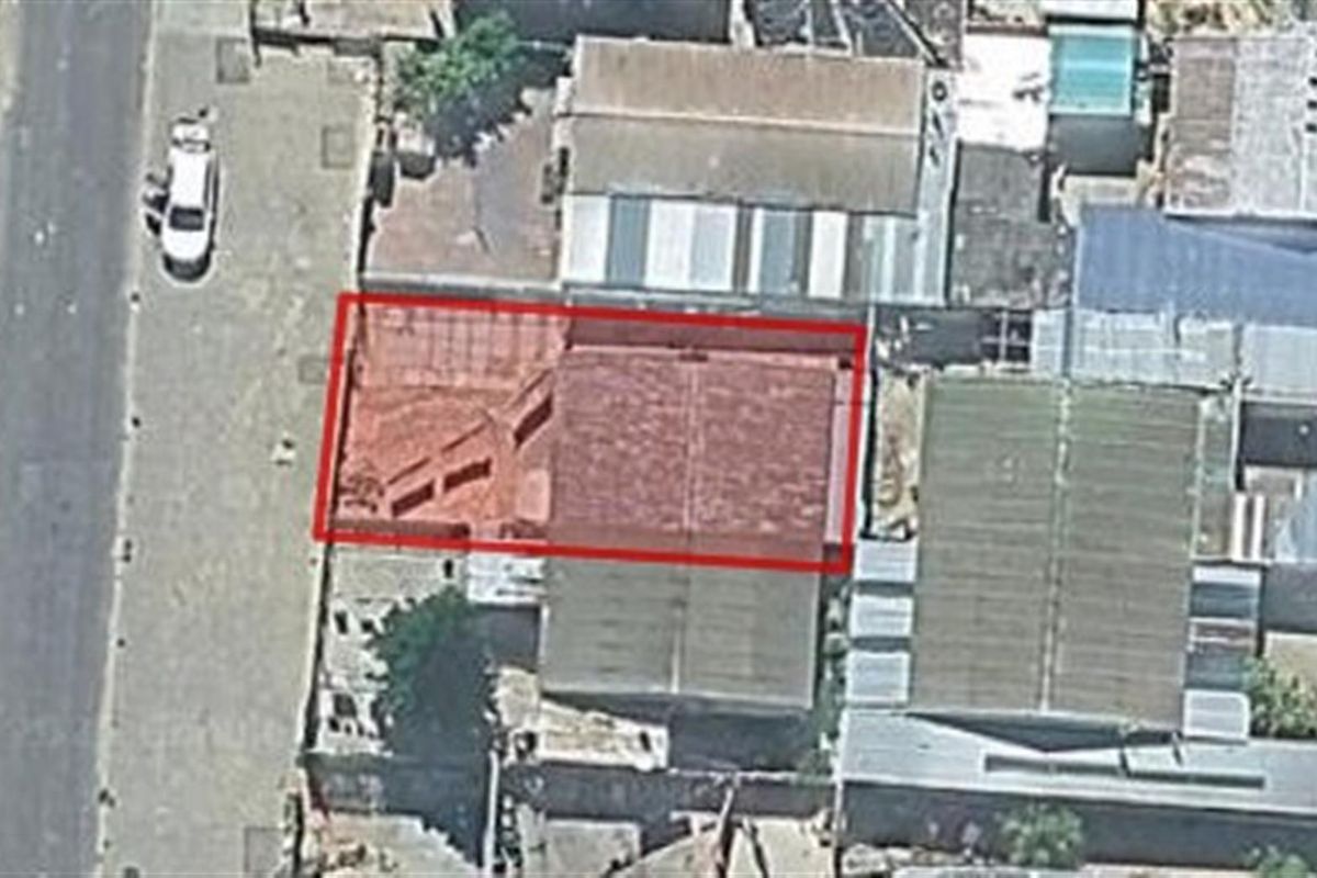 Aerial view of the property showing the roof structure and surrounding urban layout.