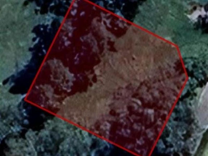 An aerial view of the vacant residential land parcel, highlighting the property boundaries and surrounding landscape.