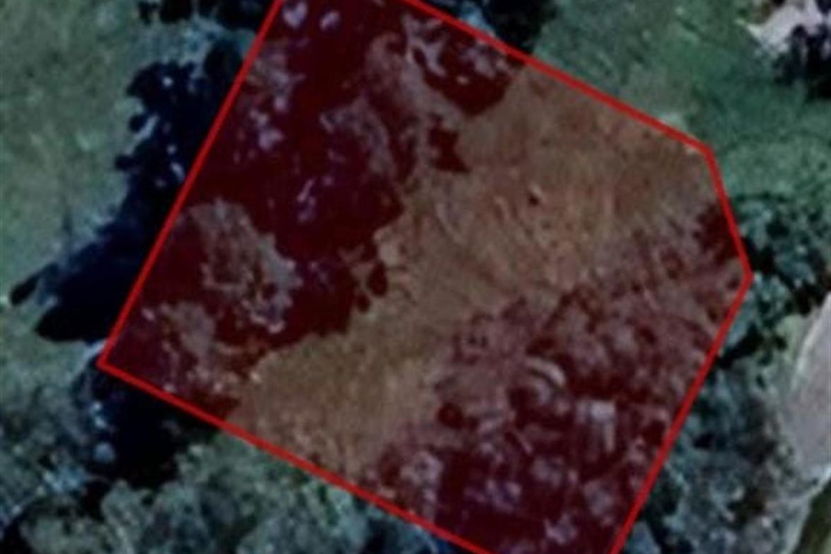 An aerial view of the vacant residential land parcel, highlighting the property boundaries and surrounding landscape.