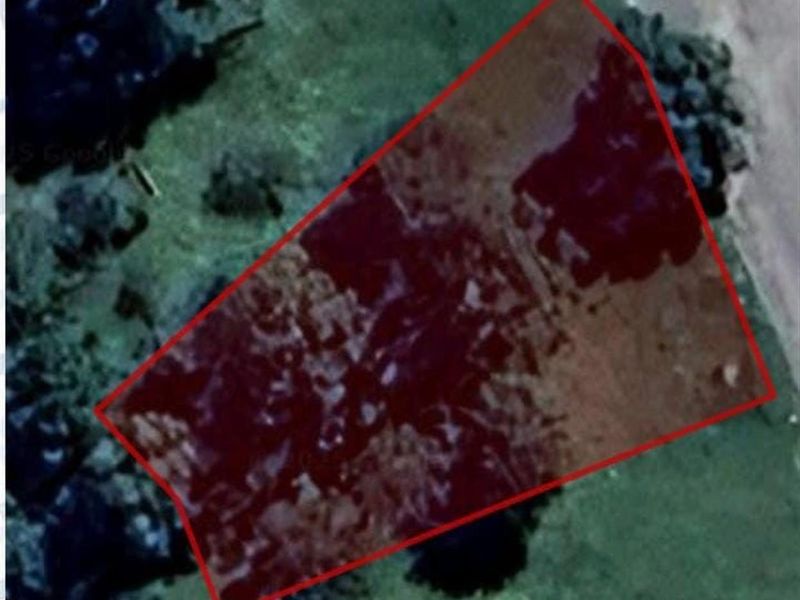 An aerial view showing the boundary of the vacant residential land plot.
