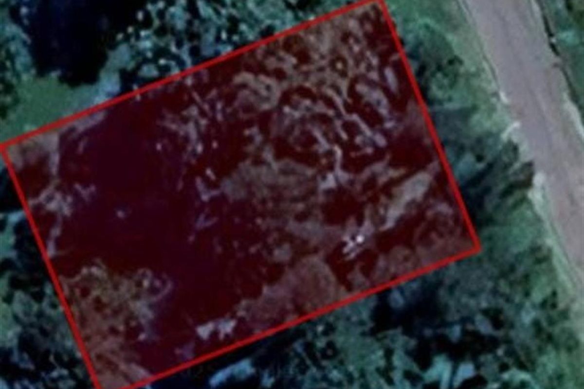 An aerial satellite view showing the boundary of the vacant residential land plot.