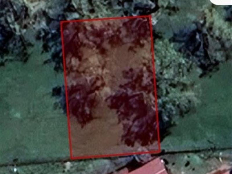 An aerial view showing the boundaries of a vacant residential land parcel.