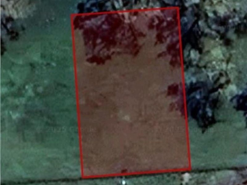 An aerial view showing the boundaries of a vacant residential land parcel.