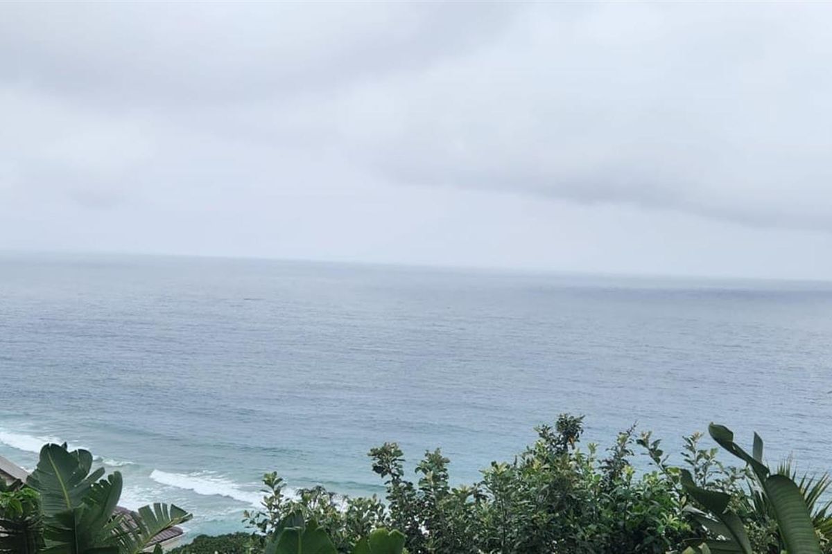 A scenic view of the ocean from the property, showcasing the coastal landscape and natural surroundings.