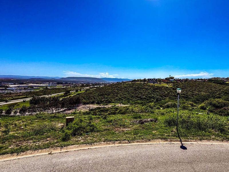 Elevated view overlooking the surrounding landscape and residential area from the vacant residential plot.