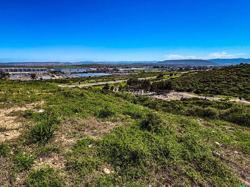 A wide-angle view of the vacant residential land, showcasing the natural landscape and surrounding area.