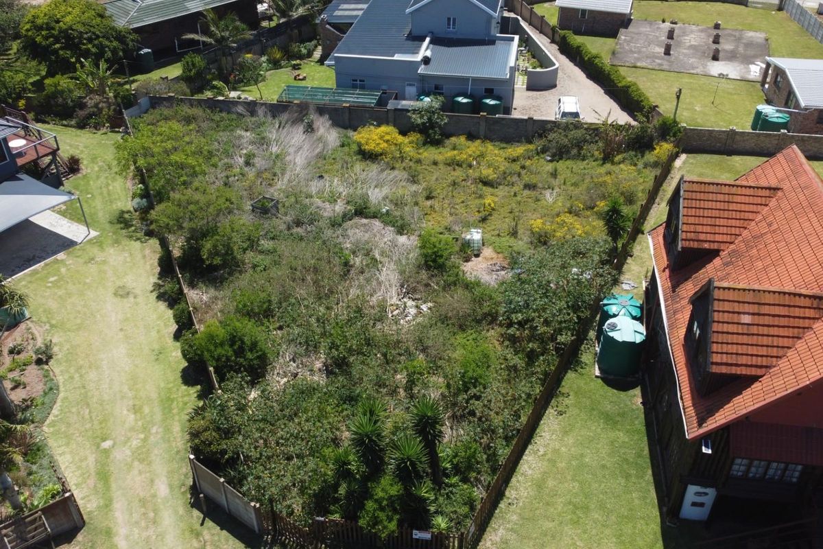 Aerial view of a vacant residential plot featuring established perimeter fencing and surrounding residential properties.