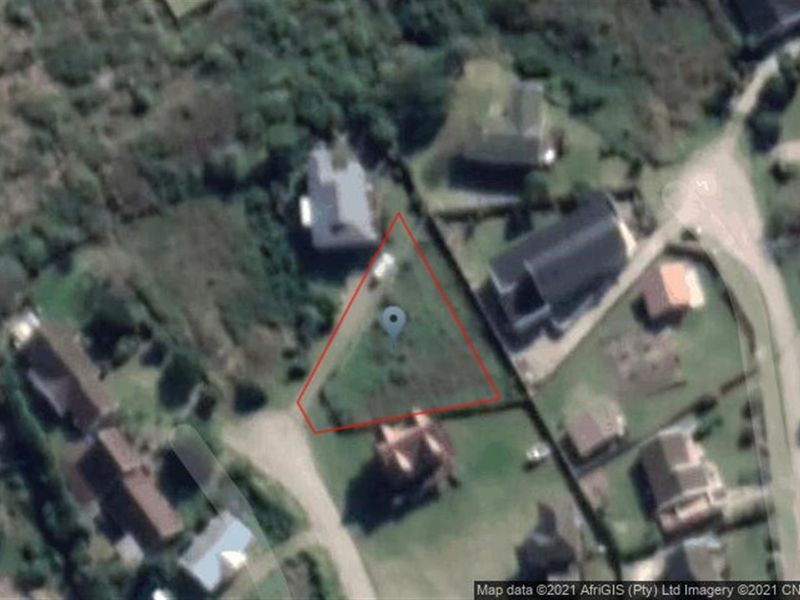 Aerial view of a vacant residential plot highlighted in a suburban neighborhood setting.