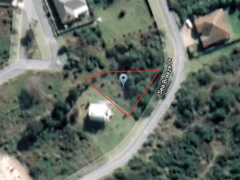 Aerial view of a vacant residential plot located on Sea Breeze Drive, showing the property boundaries and surrounding landscape.