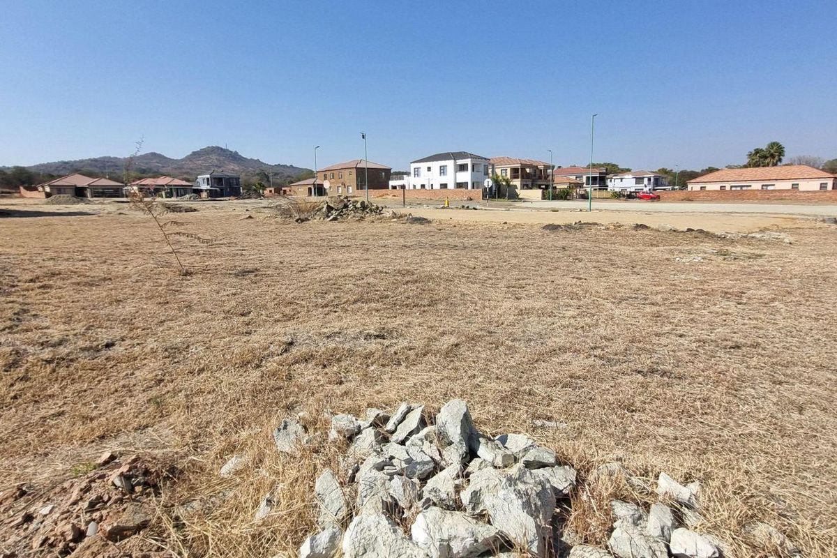A wide-angle view of a vacant residential plot in a developed neighborhood, ready for new construction.
