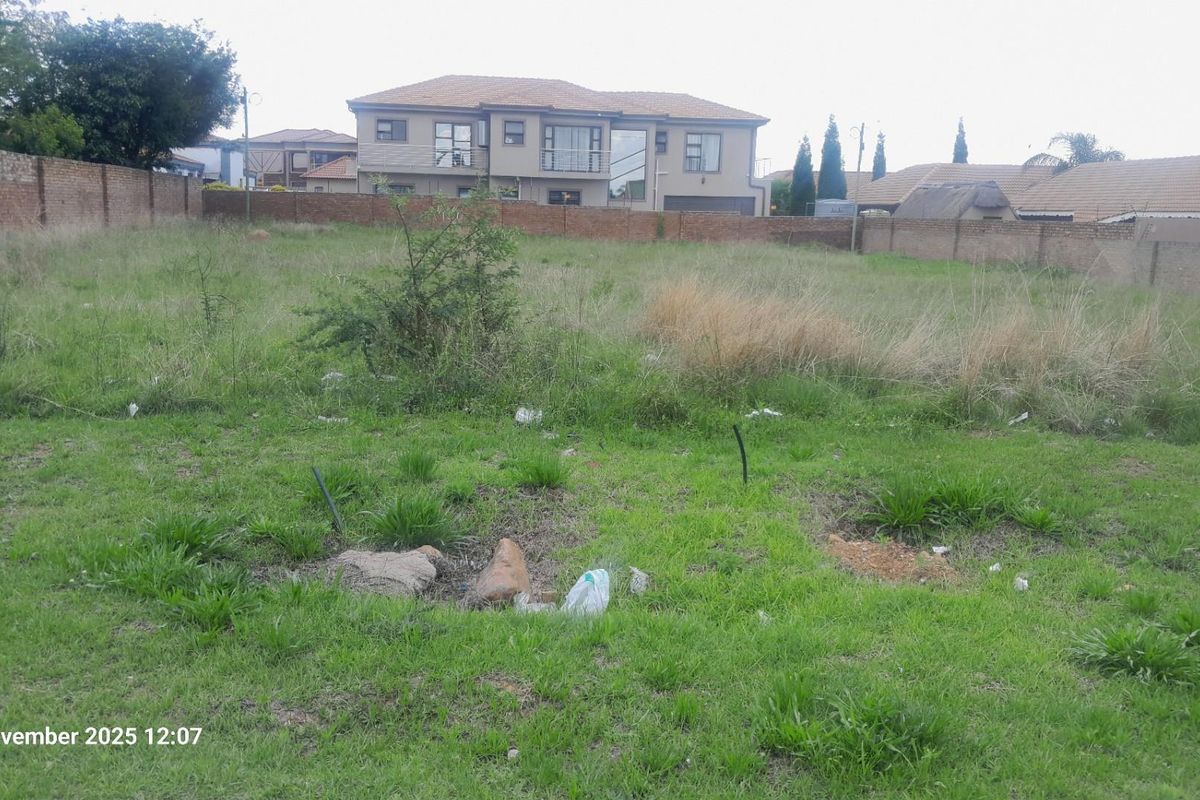 A vacant residential plot featuring perimeter brick walling, ready for development in an established neighborhood.
