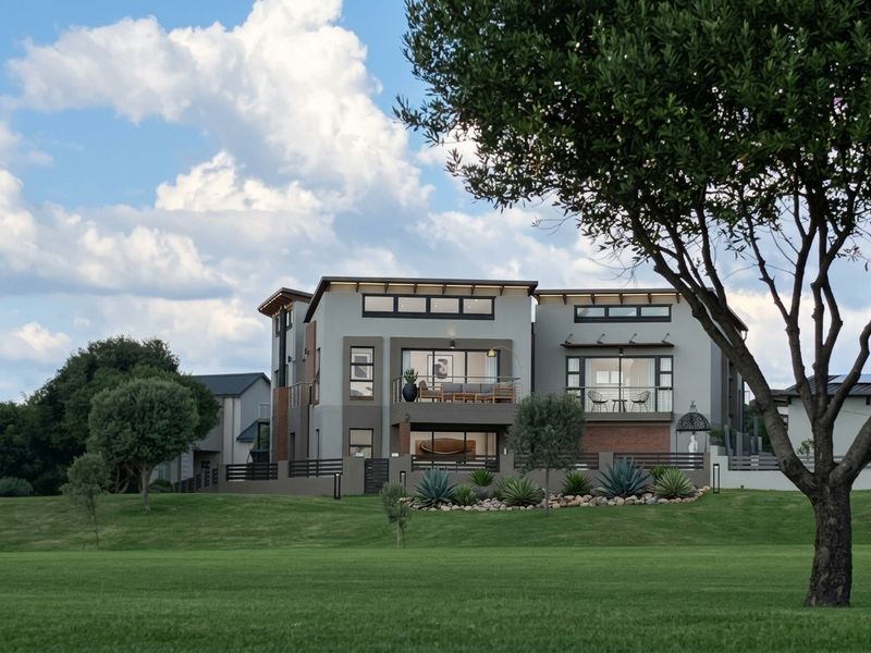 A modern multi-story residential property featuring contemporary architectural design, balconies, and well-maintained landscaped grounds.