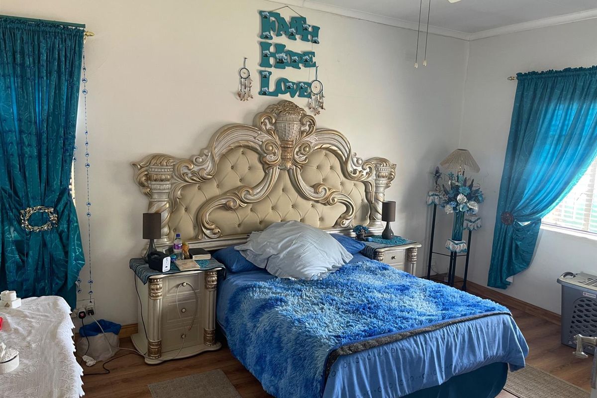 A bedroom featuring laminate flooring and a ceiling fan.